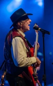SST_CMC_Bass_v2a Bassist in a cowboy hat singing harmony at the mic during a live country music show at Silver Star Theater