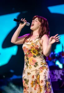 SST_CMC_Vocals_v2a Lead vocalist in a floral dress singing live at the Country Music Celebration at Silver Star Theater in Mesa, AZ
